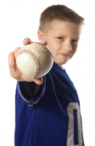 boy holding out a baseball