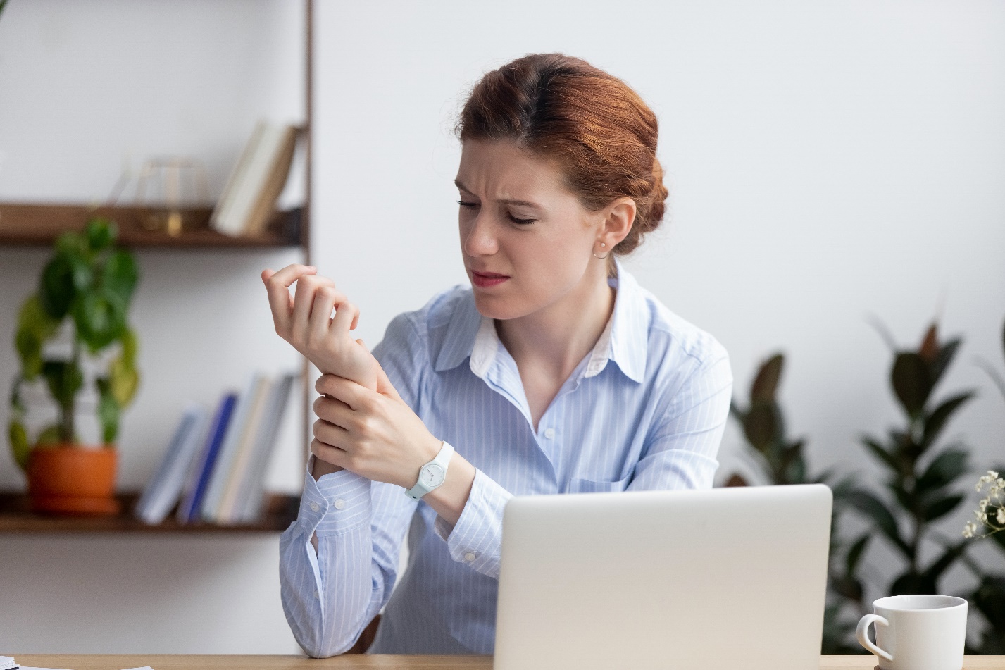 Women Holding Wrist in Pain