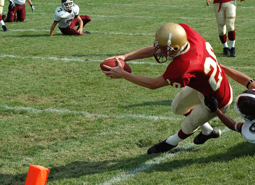 child catching football